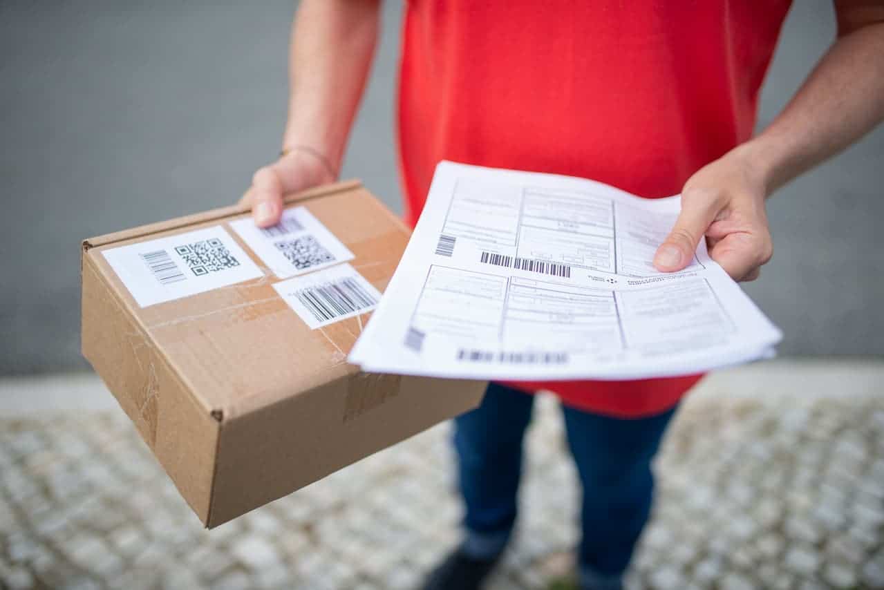 man carrying return package and documents with rma number